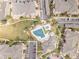 Overhead view of community with swimming pool, manicured lawns, parking areas, and residential buildings at 5765 N Genoa Way # 1-103, Aurora, CO 80019