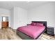 Bedroom featuring hardwood floors, neutral walls, and a comfortable bed at 5765 N Genoa Way # 1-103, Aurora, CO 80019