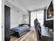Cozy bedroom with a comfortable bed, sleek desk setup and a bright window at 5765 N Genoa Way # 1-103, Aurora, CO 80019