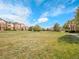 Green common area with a grassy field, mature trees, and manicured landscape at 5765 N Genoa Way # 1-103, Aurora, CO 80019