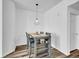 Dining area featuring modern pendant lighting and a gray dining set with open shelving at 5765 N Genoa Way # 1-103, Aurora, CO 80019