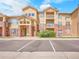Inviting condo exterior with brick accents, private balconies, and well-maintained landscaping at 5765 N Genoa Way # 1-103, Aurora, CO 80019