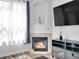 Close-up of fireplace and TV with natural light, great space for relaxation at 5765 N Genoa Way # 1-103, Aurora, CO 80019