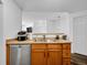 This kitchen area features stainless steel appliances, light wood cabinets and light countertops at 5765 N Genoa Way # 1-103, Aurora, CO 80019