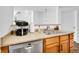 Kitchen featuring stainless steel appliances, a modern sink and a view into the next room at 5765 N Genoa Way # 1-103, Aurora, CO 80019