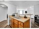 A stainless-steel sink, wood cabinetry, and modern fixtures create a stylish and functional kitchen space at 5765 N Genoa Way # 1-103, Aurora, CO 80019