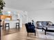 Bright living area featuring an open layout, sleek hard floors, modern furniture, and kitchen view at 5765 N Genoa Way # 1-103, Aurora, CO 80019