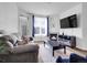 Cozy living room with fireplace, TV, comfortable seating, and natural light from the window at 5765 N Genoa Way # 1-103, Aurora, CO 80019