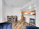 Spacious living area with dining space, kitchen, and stylish modern lighting at 5765 N Genoa Way # 1-103, Aurora, CO 80019