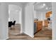 Open concept living and kitchen area with wood-look floors, white walls, and modern kitchen appliances at 5765 N Genoa Way # 1-103, Aurora, CO 80019