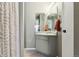 Bathroom featuring a vanity with countertop, framed mirror, and shower curtain at 8220 W 90Th Pl # 2003, Broomfield, CO 80021