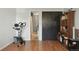 Home gym area features exercise bike, closet, shelving and wood laminate flooring at 8220 W 90Th Pl # 2003, Broomfield, CO 80021