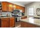 Well-equipped kitchen with stainless steel appliances, granite counters, and ample wood cabinetry at 8220 W 90Th Pl # 2003, Broomfield, CO 80021