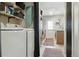 Laundry room with washer, dryer, storage shelves, and access to kitchen at 8220 W 90Th Pl # 2003, Broomfield, CO 80021