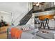 Open-concept living room with staircase, kitchen counter, and comfortable seating area at 8220 W 90Th Pl # 2003, Broomfield, CO 80021