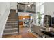 Bright living room features staircase, high ceilings, modern decor, and seamless flow to kitchen at 8220 W 90Th Pl # 2003, Broomfield, CO 80021