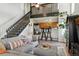 Open-concept living area with stairs, loft, breakfast bar, and contemporary furnishings at 8220 W 90Th Pl # 2003, Broomfield, CO 80021