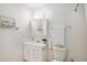 Bathroom featuring a toilet, vanity, mirror and light fixture with a towel rack at 3981 S Boston St, Denver, CO 80237