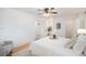 Bright bedroom with a ceiling fan, ensuite bathroom, walk-in closet and an array of pot plants at 3981 S Boston St, Denver, CO 80237