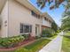 Two-story townhouse with well-maintained lawn, tidy shrubbery, and pedestrian sidewalk at 3981 S Boston St, Denver, CO 80237