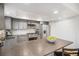 Well-appointed kitchen with island seating, gray cabinets, and stainless steel appliances at 3981 S Boston St, Denver, CO 80237