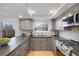 Kitchen with stainless steel appliances, gray cabinets, and plenty of counter space at 3981 S Boston St, Denver, CO 80237
