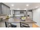 Modern kitchen with stainless steel appliances, stylish gray cabinets, and spacious countertops at 3981 S Boston St, Denver, CO 80237