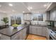 Updated kitchen with granite countertops, stainless steel appliances, gray cabinets and tile backsplash at 3981 S Boston St, Denver, CO 80237