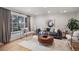 Bright living room with a large window, wood floors, and cozy contemporary furniture at 3981 S Boston St, Denver, CO 80237