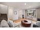 Living room features an entryway, window with curtains, and hardwood floors at 3981 S Boston St, Denver, CO 80237