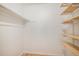 Organized walk-in closet with shelving and hanging rod for efficient storage solutions at 3981 S Boston St, Denver, CO 80237