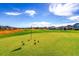 Scenic golf course view featuring a manicured green, red flag, and neighborhood homes in the background at 8017 S Valleyhead Way, Aurora, CO 80016