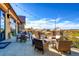 Inviting outdoor patio with comfortable seating, string lights, stone pillars and golf course views at 8017 S Valleyhead Way, Aurora, CO 80016