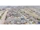 An aerial view showcases a neighborhood with various home styles against a backdrop of rolling hills and open spaces at 1445 Colebrook Ct, Castle Rock, CO 80109