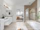Updated bathroom with double sinks, glass-enclosed shower, soaking tub and arched window view to bedroom at 1445 Colebrook Ct, Castle Rock, CO 80109