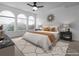 Updated bedroom with hardwood floors, neutral carpet, and three arched windows letting in natural light at 1445 Colebrook Ct, Castle Rock, CO 80109