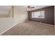 Carpeted room with a ceiling fan, large window, and neutral walls creating a comfortable and versatile space at 1445 Colebrook Ct, Castle Rock, CO 80109