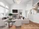 Bright, staged living room boasts hardwood floors, fireplace, and large windows, creating an inviting and airy atmosphere at 1445 Colebrook Ct, Castle Rock, CO 80109