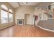 Spacious living room features vaulted ceilings, hardwood floors, a fireplace, and large arched windows for abundant natural light at 1445 Colebrook Ct, Castle Rock, CO 80109
