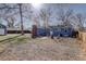 Backyard with a blue house, brick patio, and a green lawn at 4260 Newland St, Wheat Ridge, CO 80033