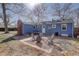 The backyard features a brick patio area, lawn, and a blue house with a brick chimney at 4260 Newland St, Wheat Ridge, CO 80033