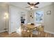 Open dining room with stylish light fixture and an arched doorway to the kitchen at 4260 Newland St, Wheat Ridge, CO 80033