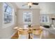 Bright dining area boasts large windows and modern table and chairs at 4260 Newland St, Wheat Ridge, CO 80033
