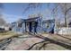Quaint home featuring a new driveway, pink door, and mature trees at 4260 Newland St, Wheat Ridge, CO 80033