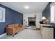 Cozy living room featuring a stone fireplace, plush sofa, and stylish decor at 4260 Newland St, Wheat Ridge, CO 80033