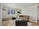 Bright living room featuring large windows, plush seating, and stylish accents at 4260 Newland St, Wheat Ridge, CO 80033