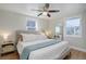 Serene bedroom with ample natural light, ceiling fan, and hardwood flooring at 4260 Newland St, Wheat Ridge, CO 80033