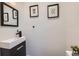Modern half-bath with a sleek vanity, contemporary fixtures, and stylish wall decor at 3829 Osage St, Denver, CO 80211