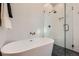 Bright bathroom features white tiles, glass shower enclosure, and modern fixtures at 3829 Osage St, Denver, CO 80211