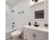 Clean, all-white bathroom featuring modern fixtures, a tiled shower-tub, and sleek design at 3829 Osage St, Denver, CO 80211